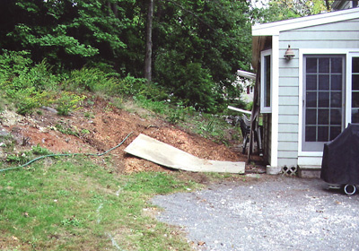 Reclaim and expand a sloping backyard and create a patio